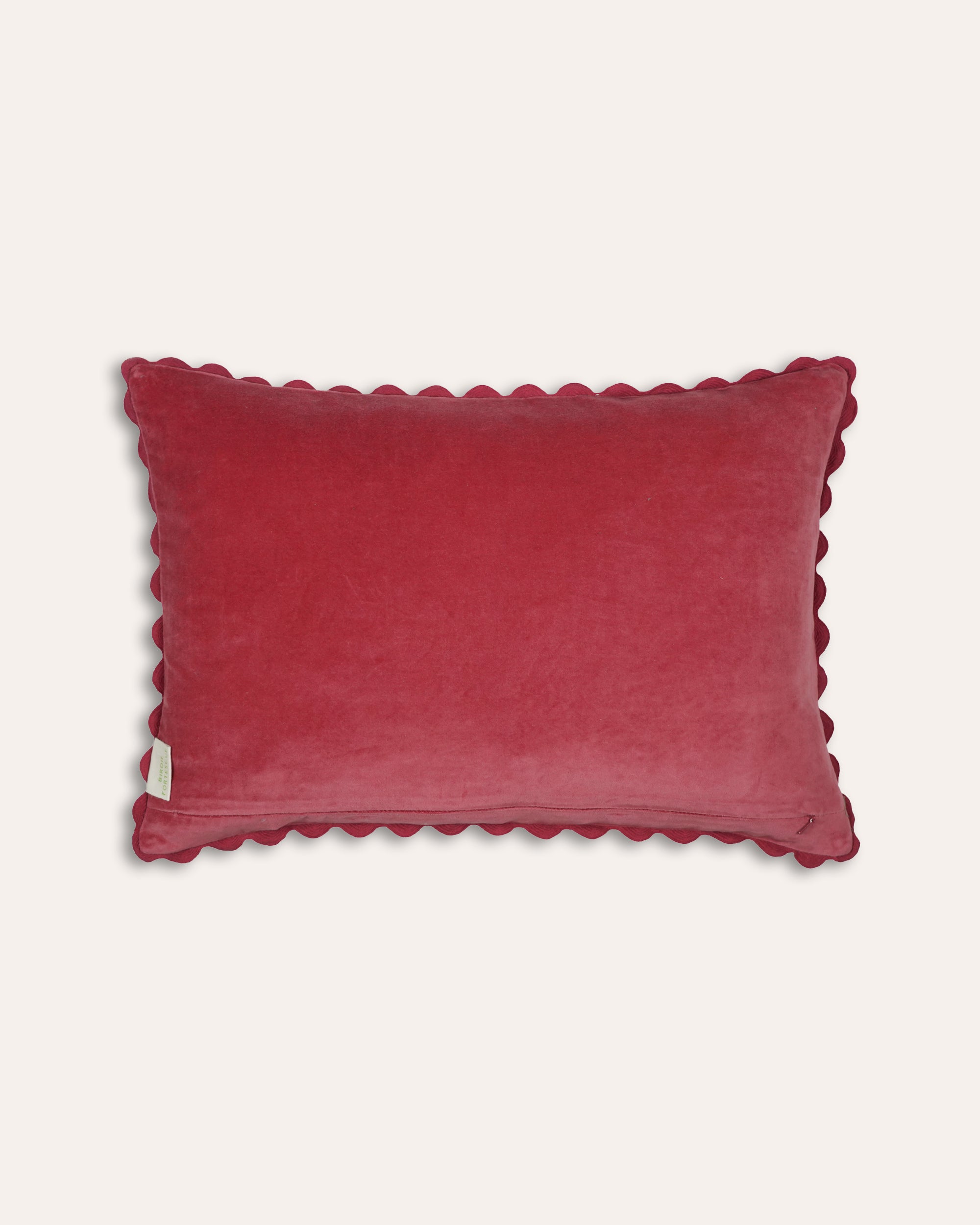 Red velvet cushion back with scalloped edge on a white background