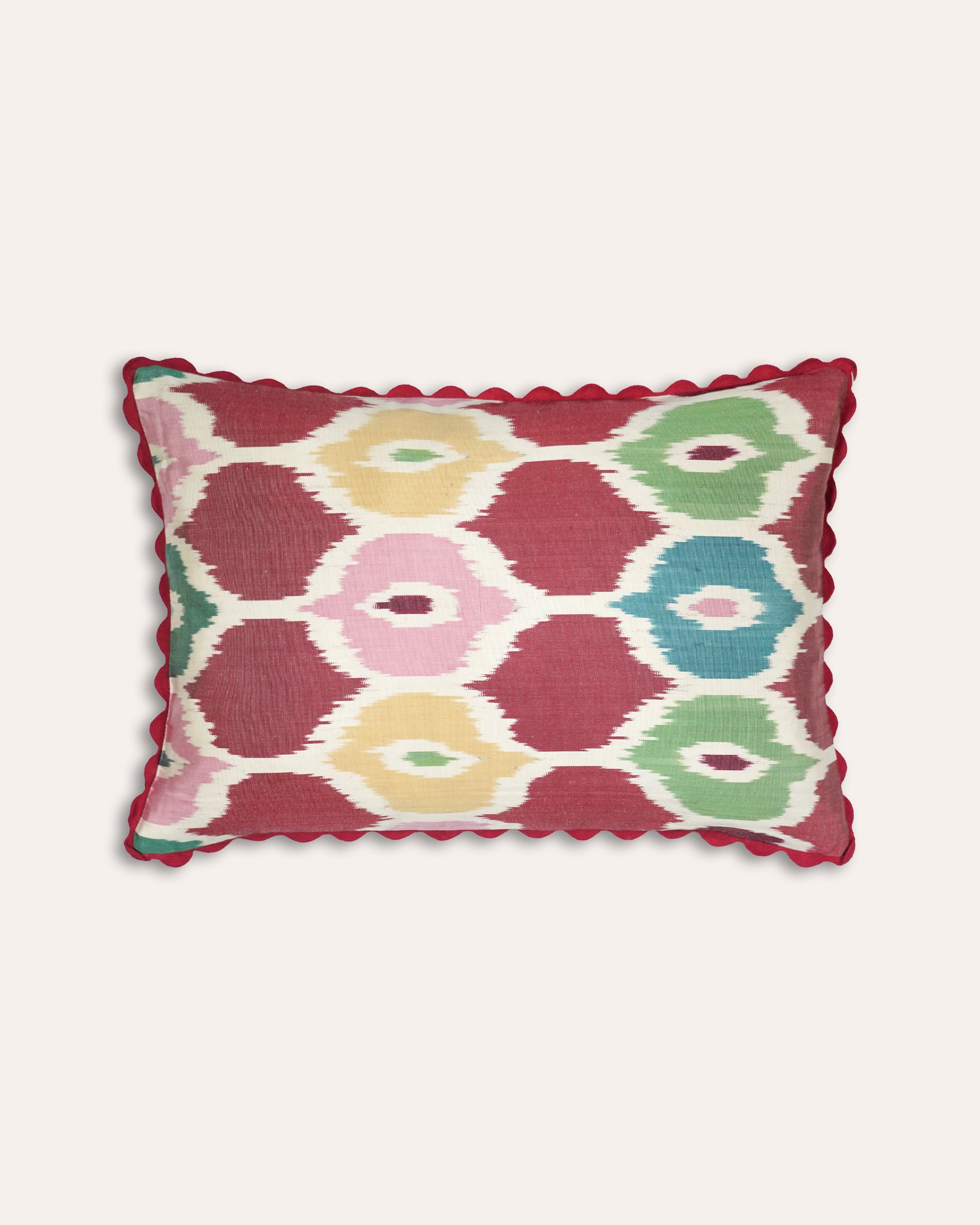 Decorative multicoloured cushion with geometric pattern on a white background