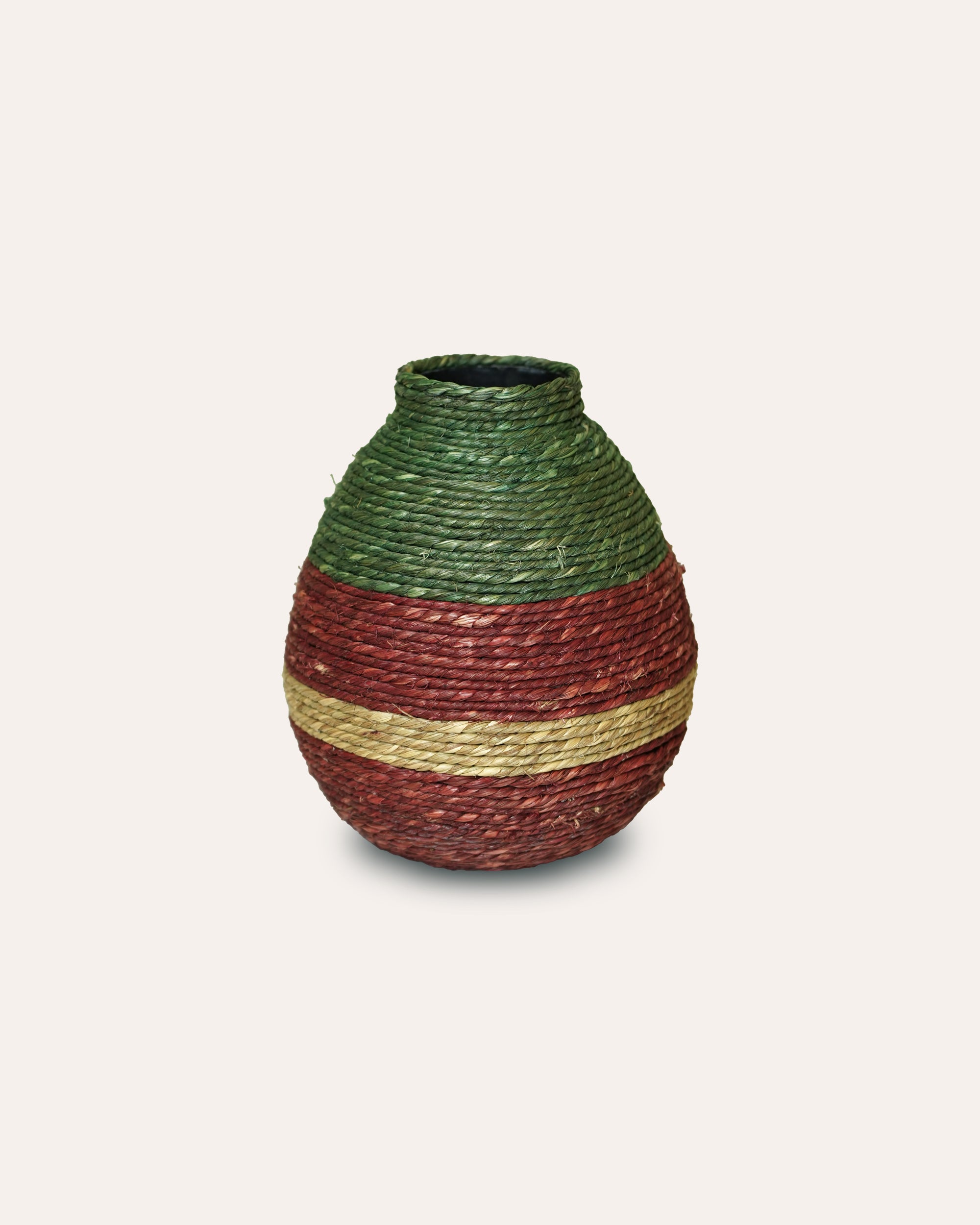 Woven vase with green top and brown body on a light white background
