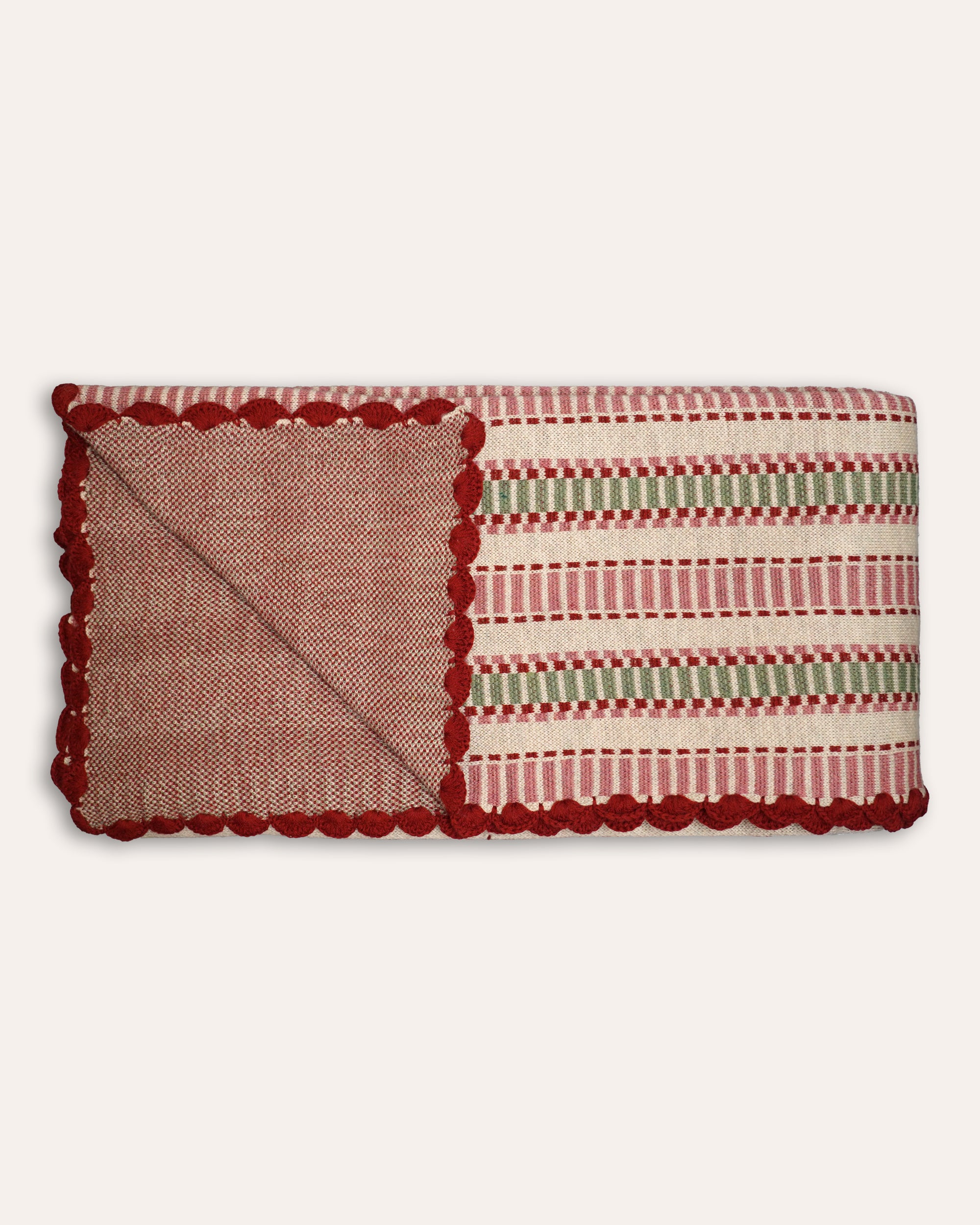Rectangular throw with red and green striped pattern on a white background