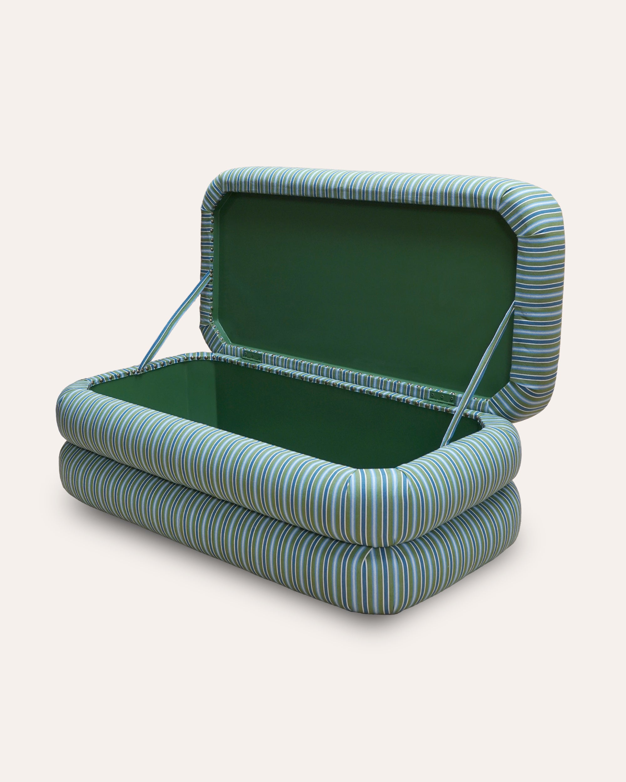 Side angle view of the striped ottoman with open lid